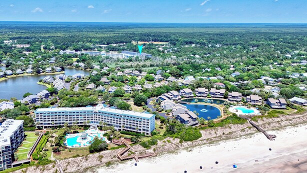 A resort with multiple swimming pools, a beach, and a large hotel building. - Seaside Inn Condo, Screen Porch, Quiet Setting, Pool Plaza, Resort Beach Access (Pawleys Island)