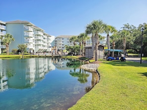 Um resort com lagoas límpidas, edifícios brancos e palmeiras.