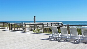 A wooden deck with white chairs overlooking the ocean. - Seaside Inn Condo, Screen Porch, Quiet Setting, Pool Plaza, Resort Beach Access (Pawleys Island)