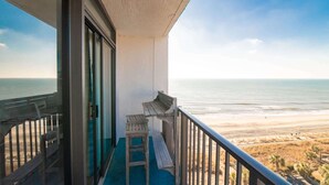 A balcony with a view of the ocean and beach. - Oceanfront Pet Friendly Modern Suite (Myrtle Beach)