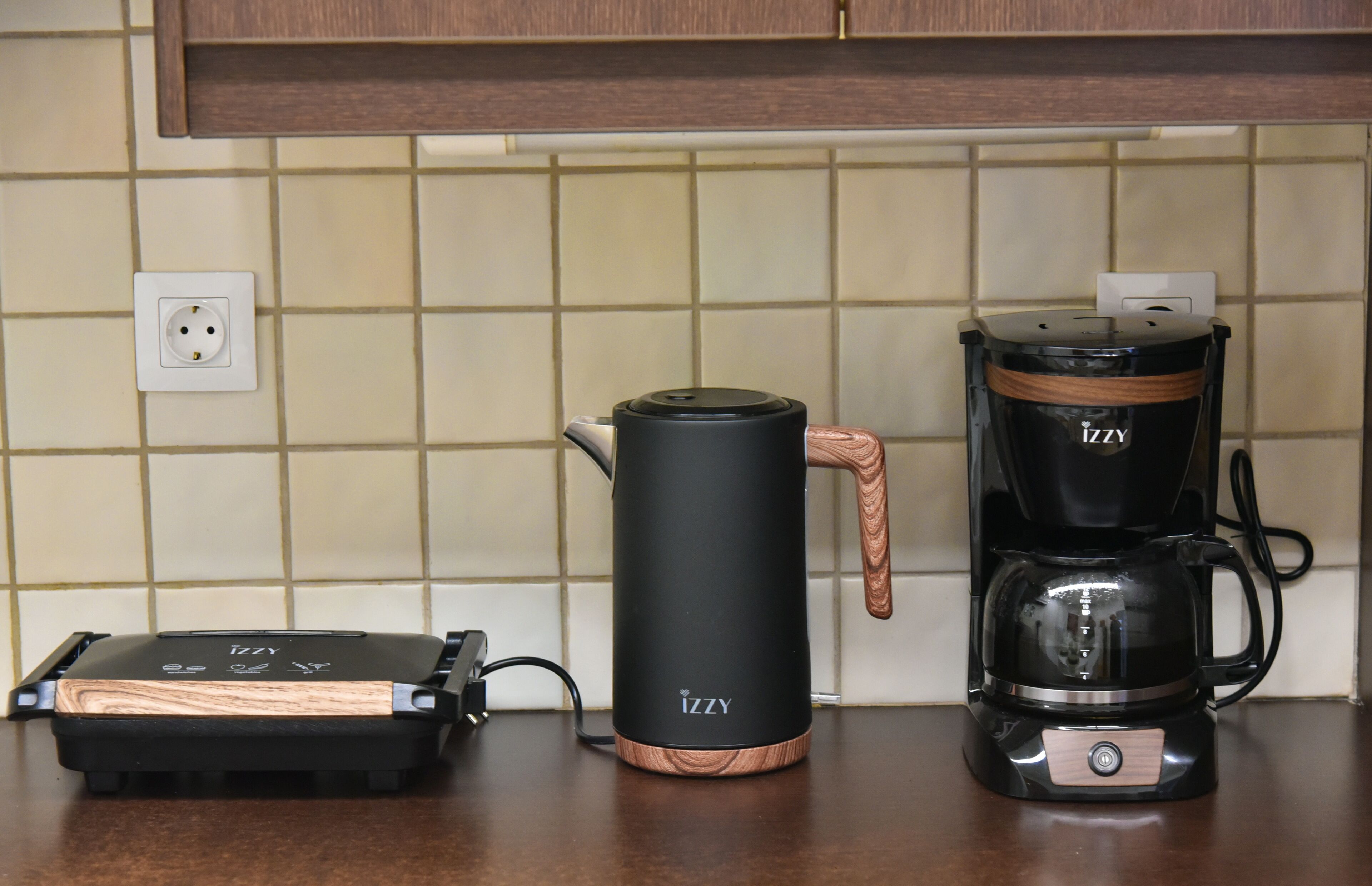 A kitchen with a coffee maker and a portable heater on the counter.