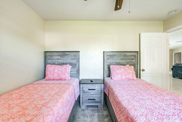 A bedroom with two beds, each with a headboard, a small bedside table, and a drawer. - Hot Tub & Outdoor Pool: Bonita Springs Getaway! (Bonita Springs)
