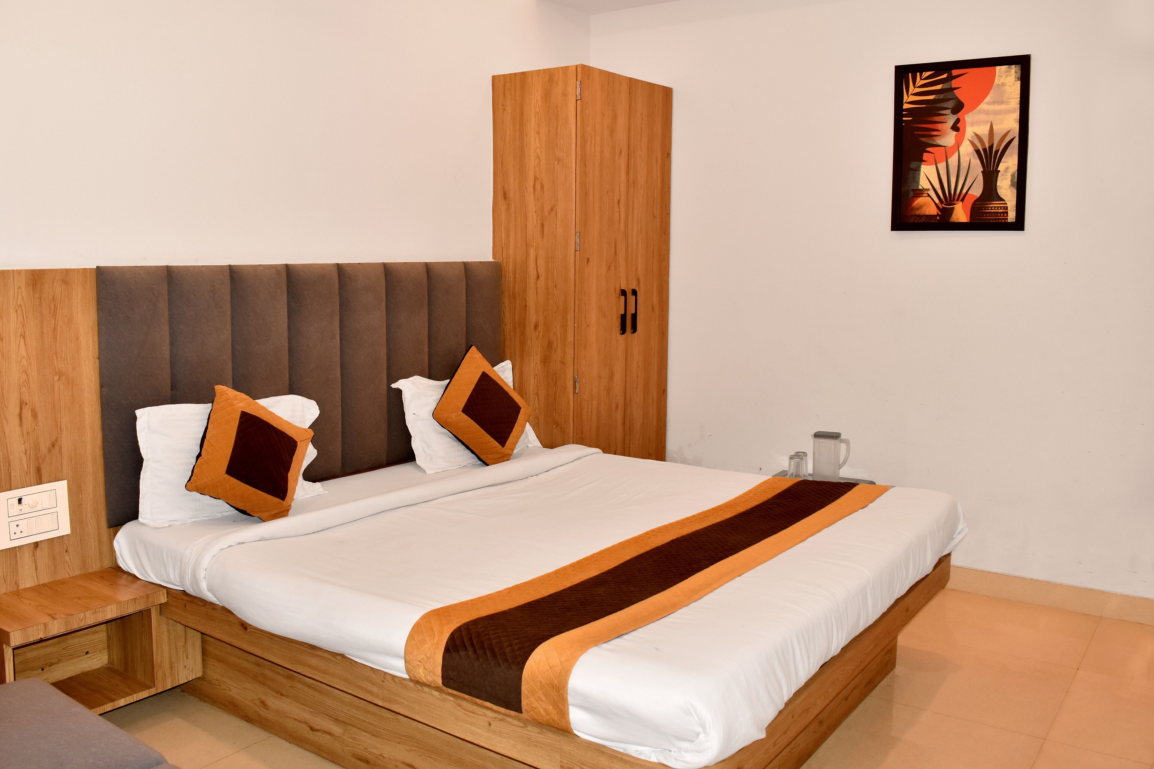 A bedroom with a wooden bed frame, a headboard, a wardrobe, and a wall-mounted artwork.