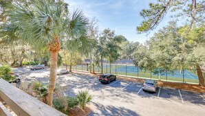 A view of a tennis court with a parking area and trees. - < 1 Mi to Coligny Beach Park: Condo w/ Tennis! (Hilton Head Island)