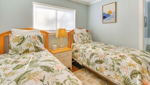 A bedroom with two single beds, a nightstand, a lamp, and a window with blinds. - < 1 Mi to Coligny Beach Park: Condo w/ Tennis! (Hilton Head Island)