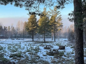 A snowy forest with picnic tables and a clear sky. - 2 Person Holiday Park Home in Orsa (Orsa)