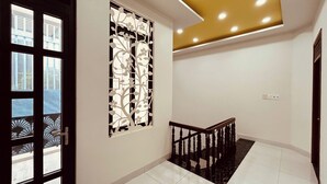 A staircase with a wooden handrail and a decorative wall panel.