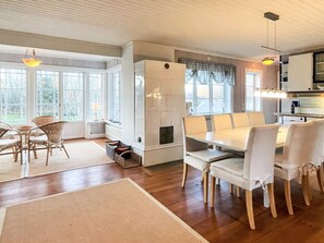 A spacious kitchen with a dining area, large windows, and a view of the outdoors. - 4 Star Holiday Home in Farjestaden (Farjestaden)