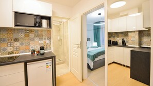 A compact kitchen with a microwave, coffee maker, and a dishwasher.
