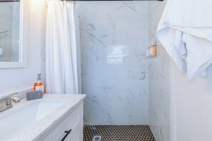 Shower, hair dryer, towels, soap