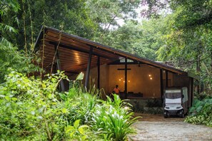 A rustic wooden structure with a sloped roof, surrounded by lush greenery. - Klov Resort & Spa (Mananthavady)