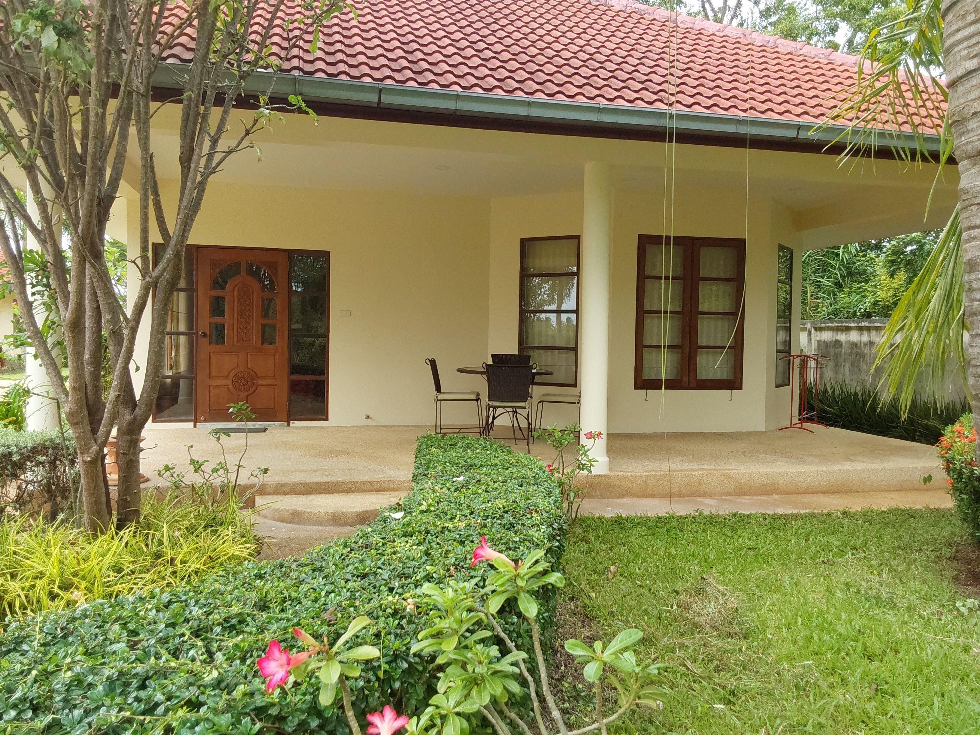A house with a covered porch, a door, and a window.