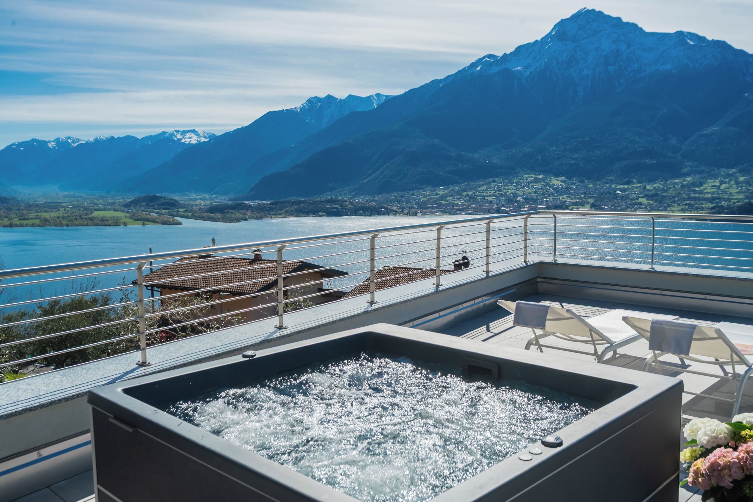 A hot tub on a balcony with a mountain view.