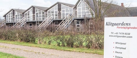A row of traditional houses with multiple windows and a staircase leading to a second floor.
