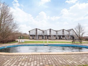 A two-story building with a swimming pool in front. - 2 Person Holiday Home in Hojer (Højer)