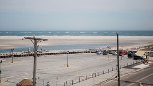 A parking lot with a view of the beach and ocean. - Steps Away From All the Fun (Wildwood)