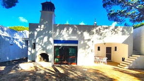 A building with a central entrance, a small tower, and a staircase leading to an upper level. - Albufeira Açoteias Villa by Homing (Albufeira)