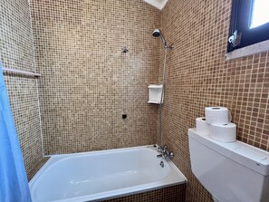 A bathroom with a bathtub, a shower, and a toilet.