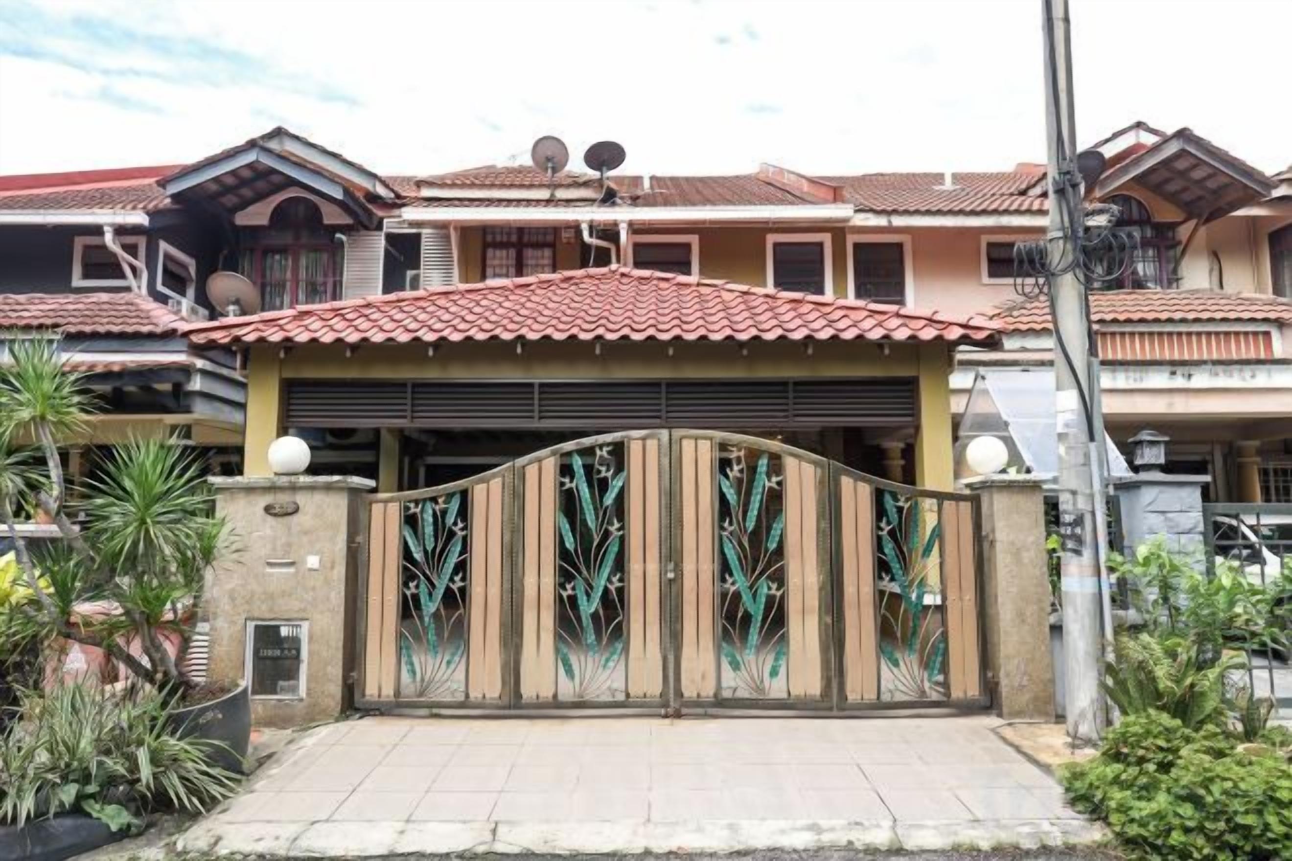 A gated residential property with a tiled roof, a garage, and a gated entrance.