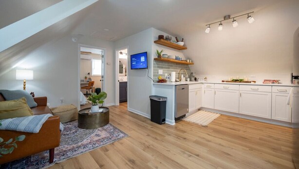 A modern apartment with a living room, kitchen, and dining area. - *Whole House* | 4-BR Home | 2 Kitchens + Free WiFi (Lynchburg)