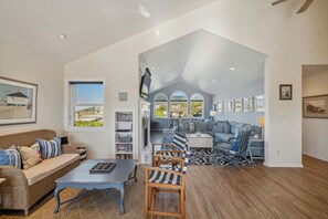 A spacious living area with a high ceiling, a large window, and a view of the outdoors. - Oceanview, gourmet kitchen,4 bdrm, 1 house off the beach, dog ok-Great Escape (Manzanita)