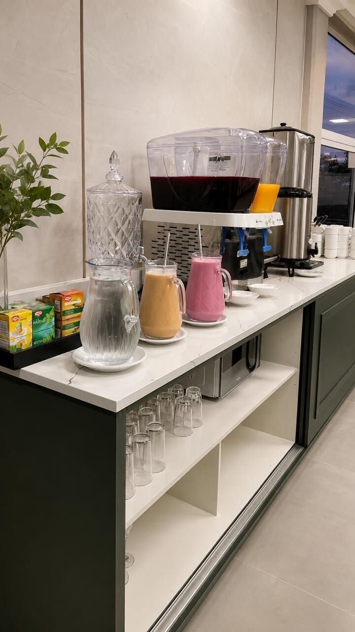 A kitchen counter with a coffee maker, a blender, and a pitcher.