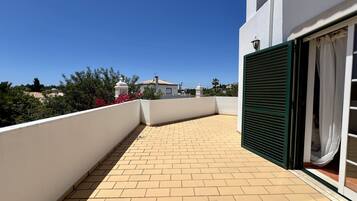Enjoy the serene views from this balcony with a door leading to a charming outdoor space.