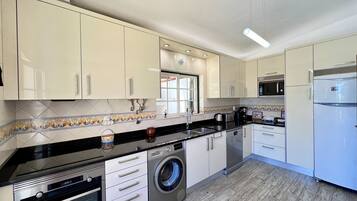 Microwave, dishwasher, coffee/tea maker, cookware/dishes/utensils