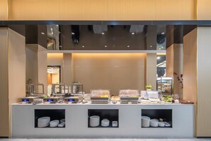 Ein reichhaltiges Buffet mit verschiedenen Speisen und Servierstationen.