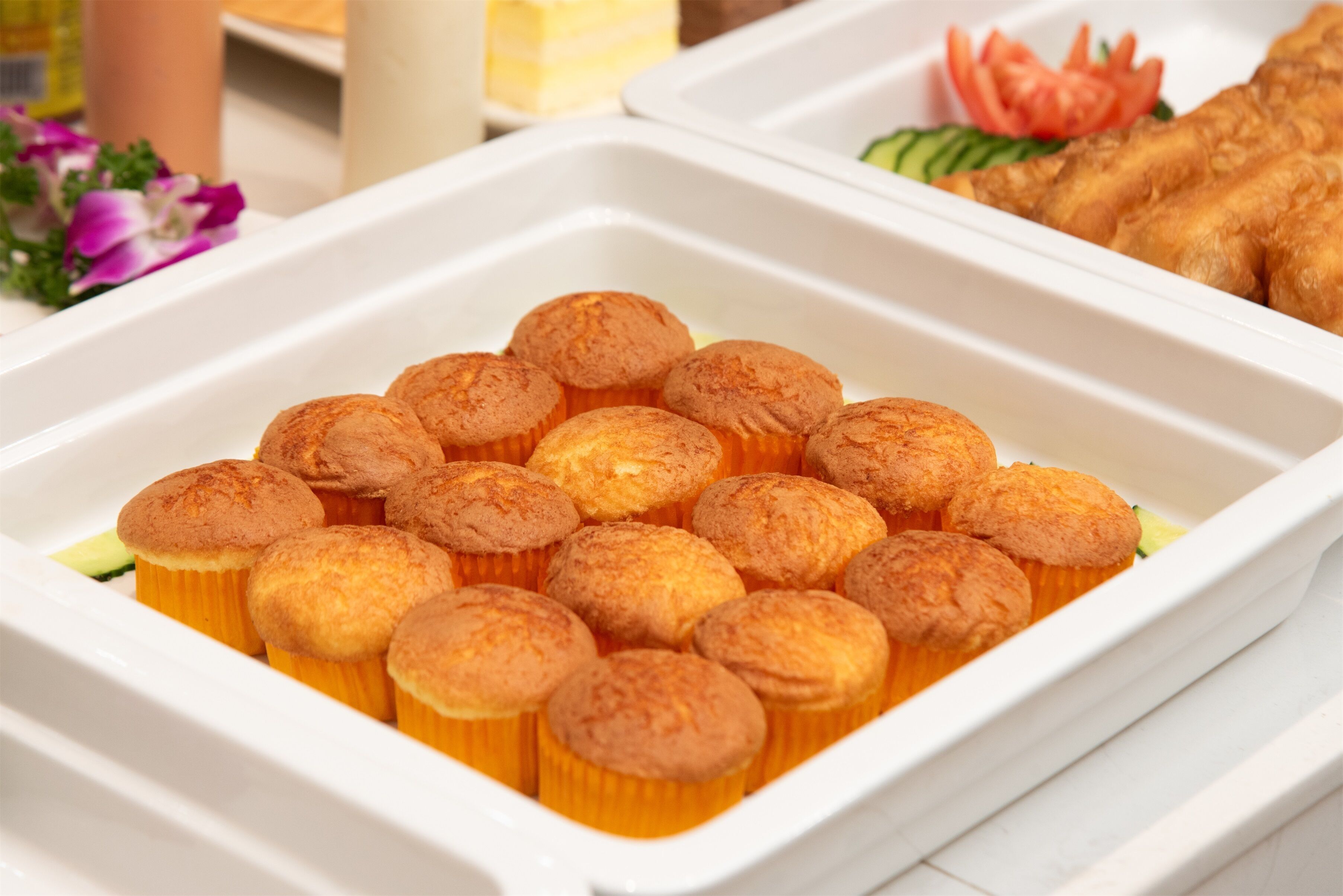 A tray of muffins in a white container.