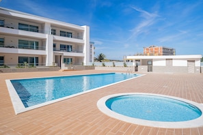 A modern building with a swimming pool and a separate circular pool. - Lagos Marina View 3 With Pool by Homing (Lagos)