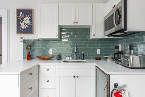 Fridge, microwave, coffee/tea maker, cookware/dishes/utensils