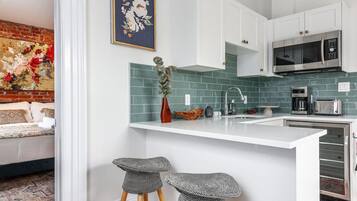 Fridge, microwave, coffee/tea maker, cookware/dishes/utensils