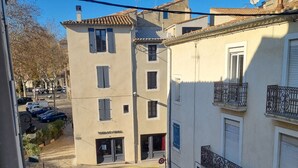 A street view with a building featuring a storefront named 'BOUCHERIE CHEVALINE'. - Cosy mezzanine studio in Narbonne town center, close to beaches (Narbonne)