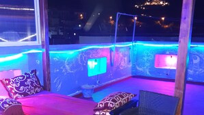 An outdoor seating area with a sofa, chairs, and a table. - aline hostel (Chefchaouen)