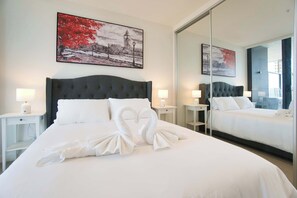 Restful retreat with a large bed, tufted headboard, and crisp linens.