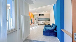 A modern interior with a dining area, kitchen, and seating space.