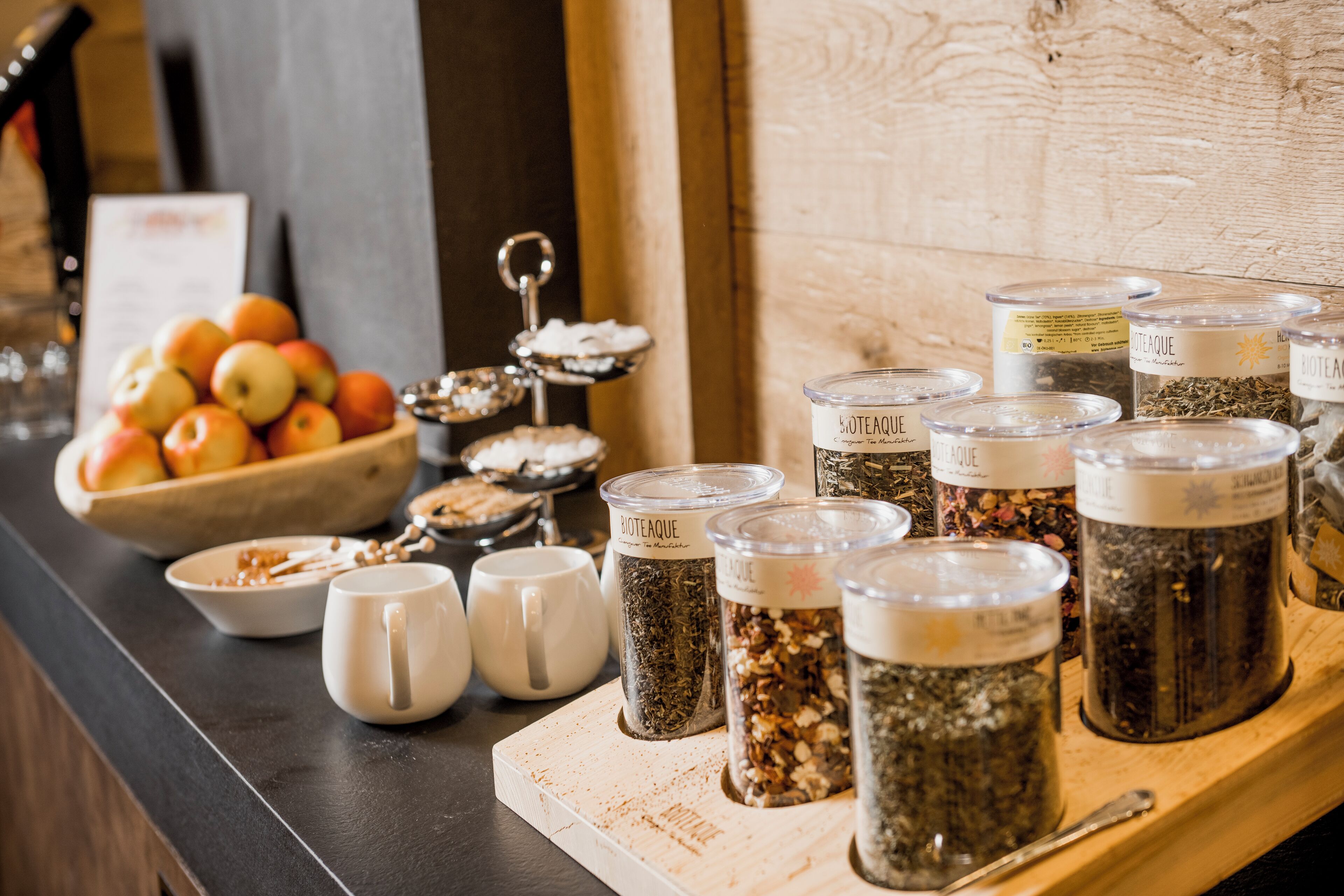 A buffet table with various food items and containers of beverages.