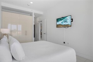 Sink into this plush, king-size bed and enjoy a restful night’s sleep - Thoughtfully designed with warm lighting, elegant furnishings, and plenty of storage - A peaceful and inviting retreat, perfect for unwinding after a day of adventure - Modern Caribbean 2BR Condo with Pool Access, Noord (Noord)