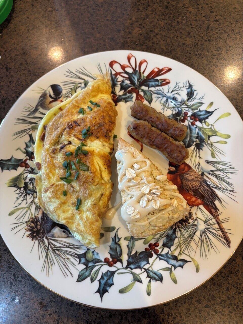 A plate with a rolled omelette, sausage slices, and a baked item with oats.