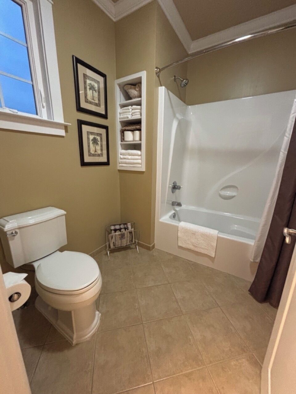 A bathroom with a toilet, a bathtub, and a shower.