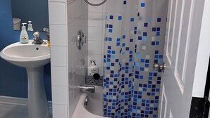 A bathroom with a bathtub, a sink, and a shower. - Monthly rental - 1-BDR apt, ALL included (hot water, hydro and heating). (Ottawa)