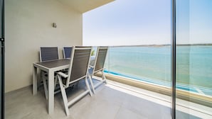 A balcony with two chairs and a table, overlooking a body of water. - Portimão Ocean Breeze by Homing (Lagoa)
