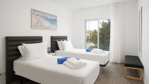 A hotel room with two beds, a bench, a large window with a view, and a painting on the wall. - Lagos Modern 1 With Pool by Homing (Lagos)