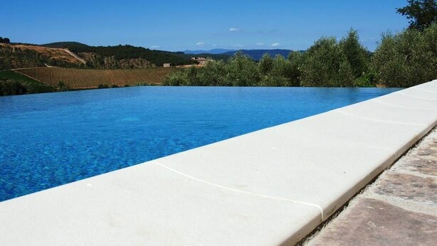 A swimming pool with a clear view of the surrounding landscape, including hills and trees. - Villa W/Infinty Pool Villa in the Heart of Chianti (Tregole)