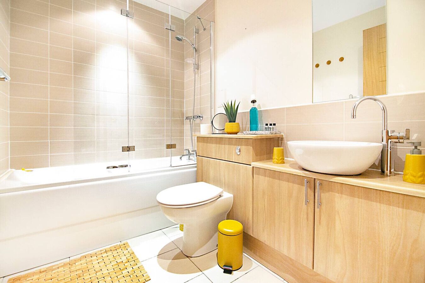 A modern bathroom with a bathtub, toilet, and sink.