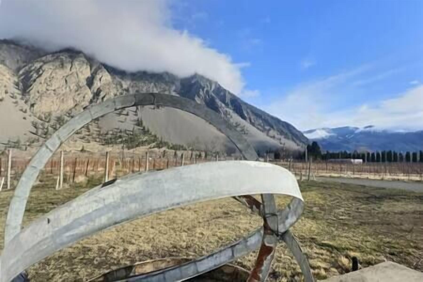 A mountainous landscape with a metal structure in the foreground.