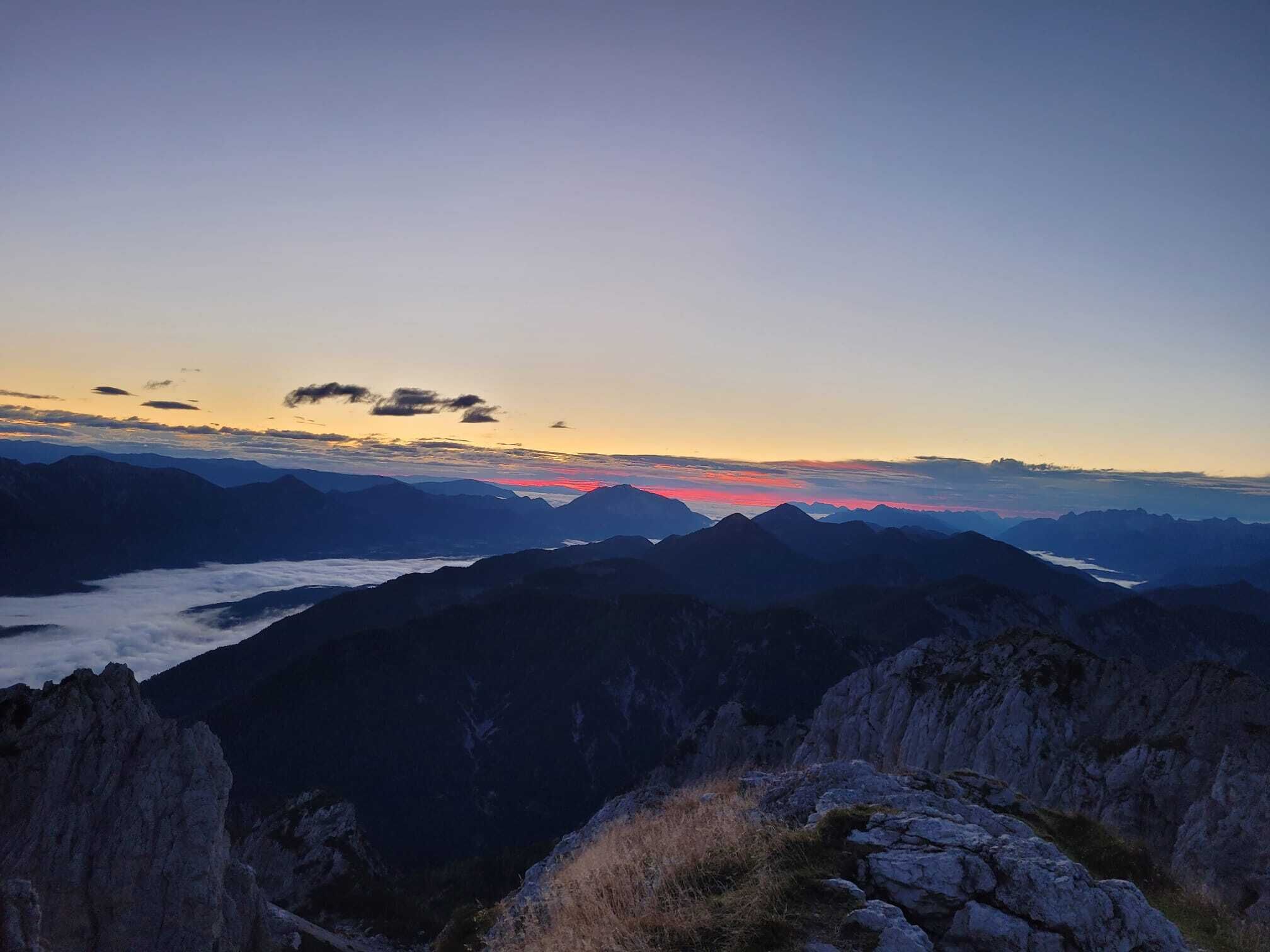 A mountainous landscape with a clear sky and a sunset.