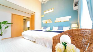 A bedroom with a bed, a wicker chair, a potted plant, and a wall-mounted shelf. - Awaji Central Inn Kuruma713 (Awaji)