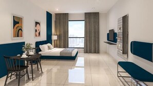 A modern hotel room with a bed, a dining table with chairs, a TV, and a large window with curtains. - Mossaz Suites by MyKey (Petaling Jaya)